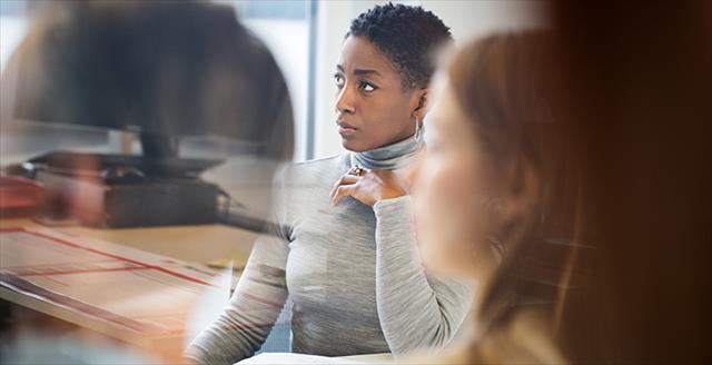 woman at work meeting looking concerned