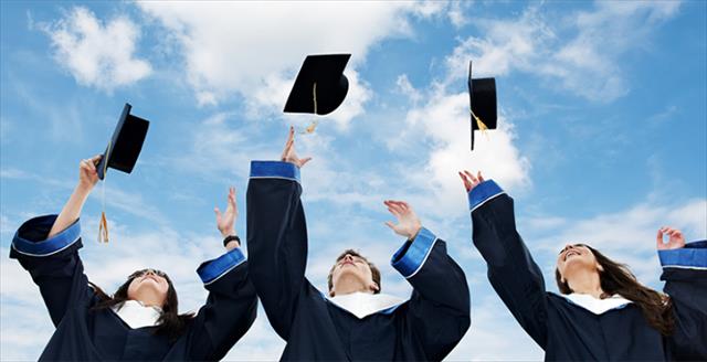 graduates tossing caps in the air