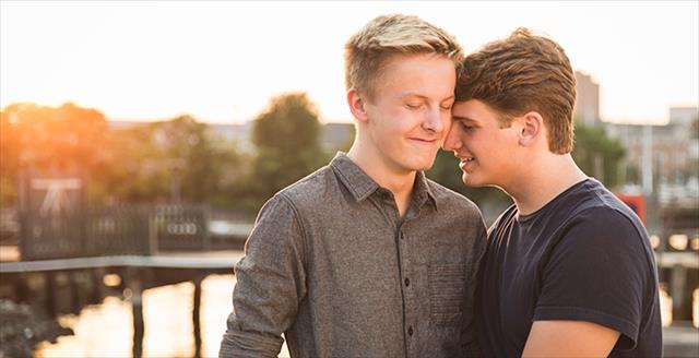 two young men hugging
