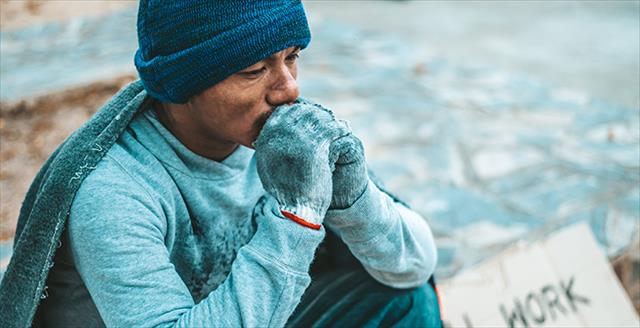 homeless man sitting outside