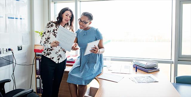 to women collaborating in an office