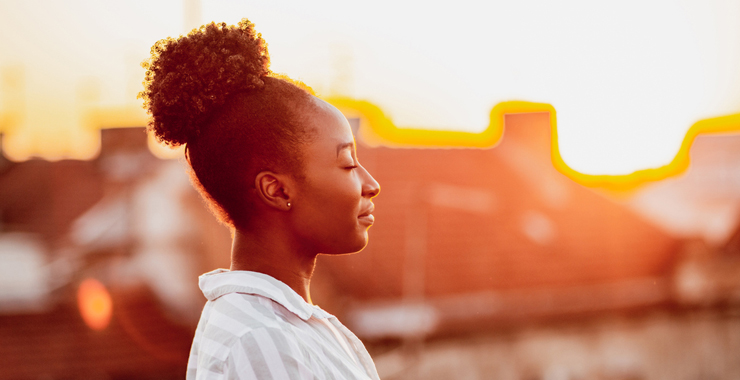 woman of color with her eyes closed and smiling