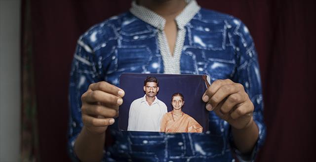 child holding a picture of his parents