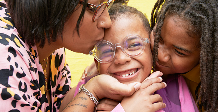 woman of color kissing her child