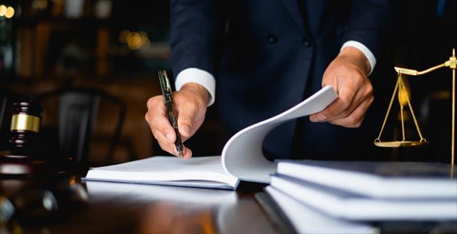 Judge writing in notebook