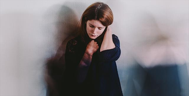 woman looking sad sitting on the floor