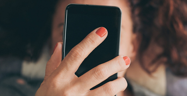 woman staring at a smartphone
