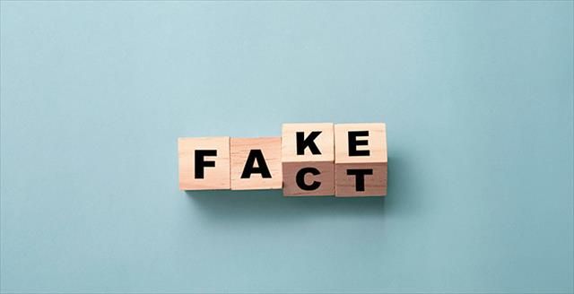 wooden blocks spelling the words fact and fake