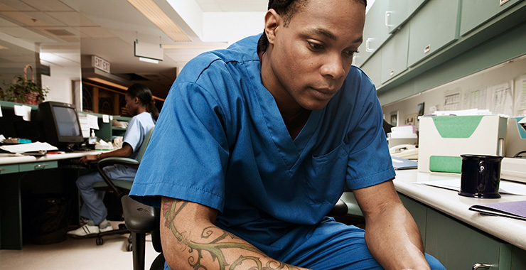 health care working in scrubs sitting in a chair