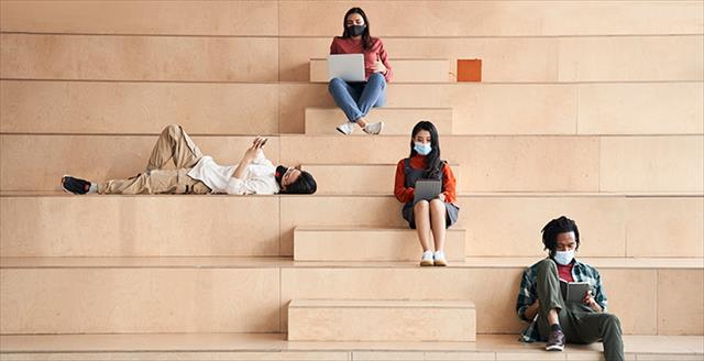 several college students sitting on bleachers