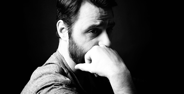 image of man looking pensive with his hand under his chin