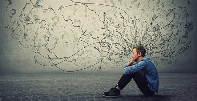 teenage boy sitting on the ground with graphic of curly lines around his head