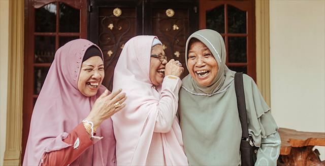 three aging adult sisters laughing with each other