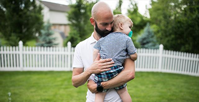 father holding his toddler son