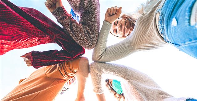 group of young people giving each other an elbow bump