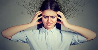 woman looking stressed with her hands on either side of her head