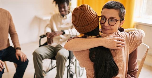 two young adults hugging