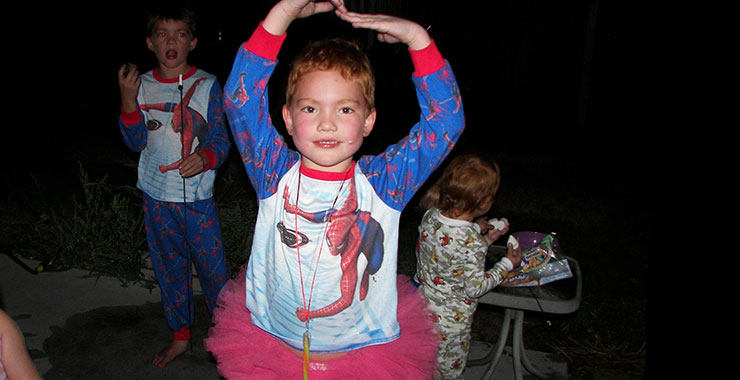 young boy wearing a tutu