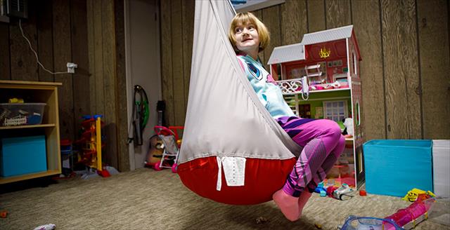 young girl sitting in a pillow chair
