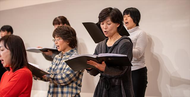 group of adults singing in a choir