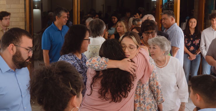 group of adults comforting each other