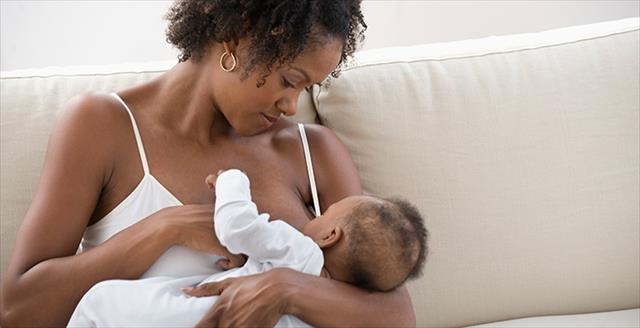 Black woman breastfeeding an infant