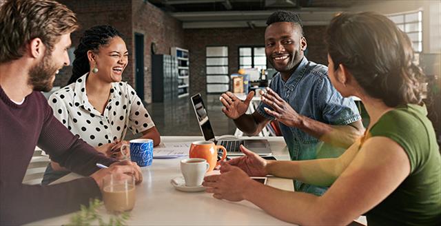 four young adults having a discussion over coffee