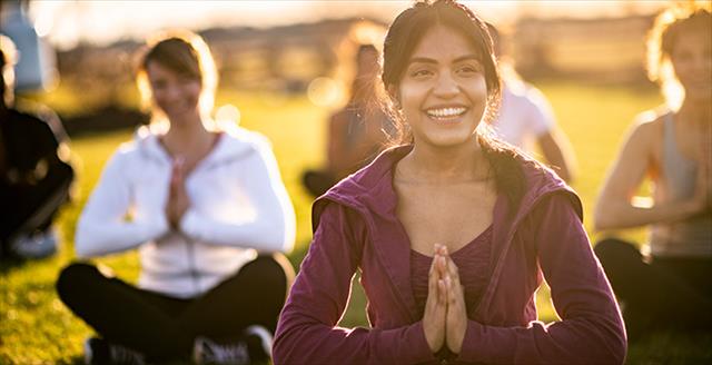 group of people participating in an outdoor yoga class