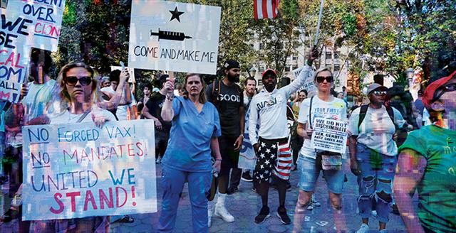 protestors with signs against vaccination