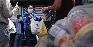 people handing out bags of food