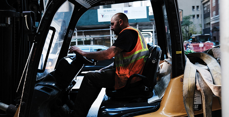 man wearing a safety vest while driving a truck