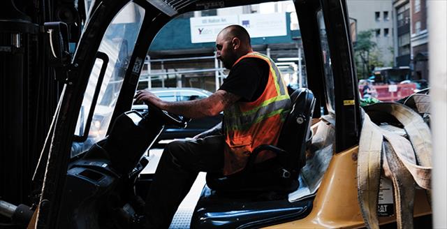 man wearing a safety vest while driving a truck