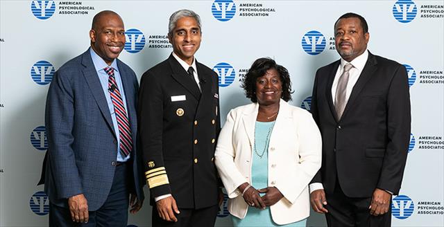 U.S. Surgeon General standing with APA's Dr. Evans and others