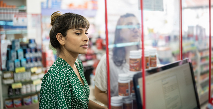 woman standing at a pharmacy counter