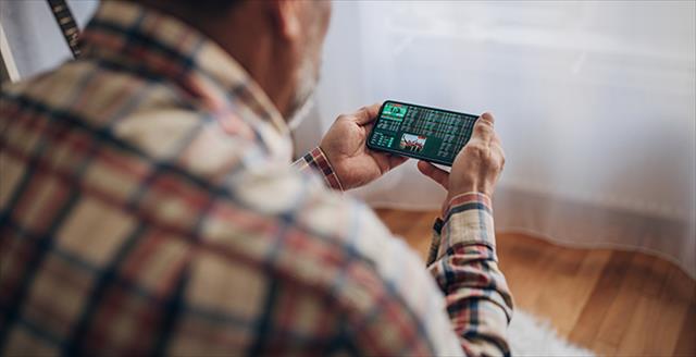 man using a smartphone to gamble