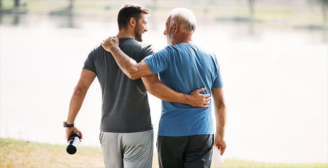 two men walking with an arm around each other