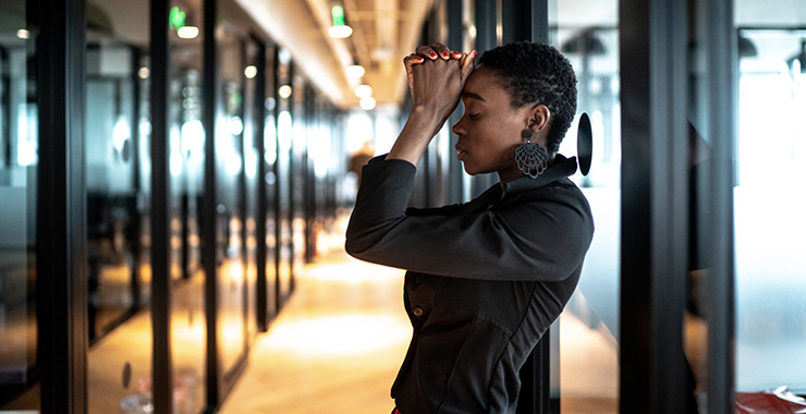 woman looking stressed with her hands on her forehead