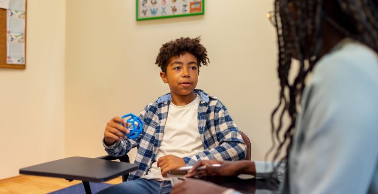 Black student consulting with teacher