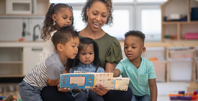 teacher reading to several young children