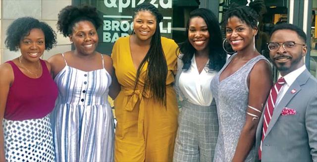 Blacks in I/O founders Macy Cheeks and Shavonne Holman and other members stand together