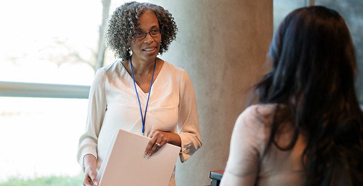 faculty member speaking with a graduate student