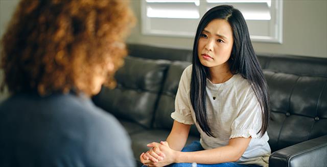 young woman speaking with a counselor