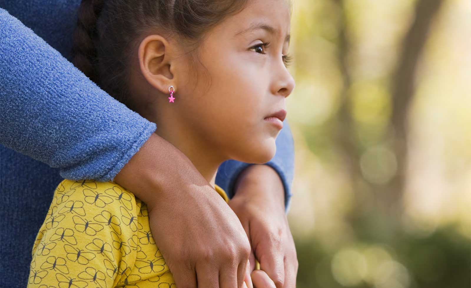 young girl being comforted by her mother
