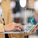employee working on laptop with superimposed transparent screen