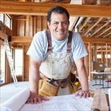 man looking at architectural plans at building site