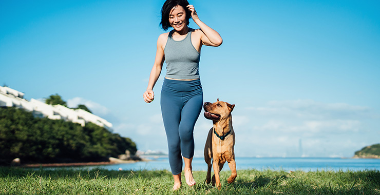 woman walking outside with her dog