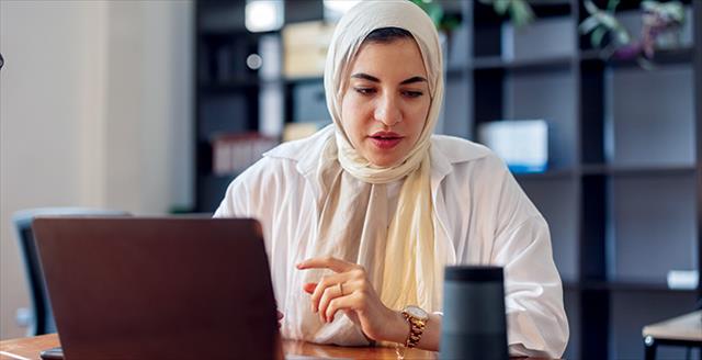 woman having a conversation in front of a laptop