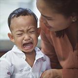 child crying with a mother trying to calm