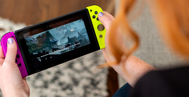 person playing a handheld video game