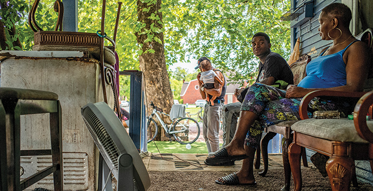 family sitting outside in the shade